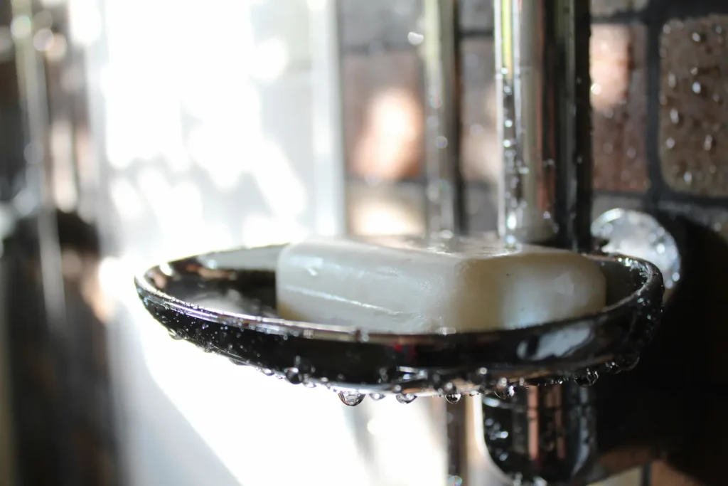 A soap case shower appliance with accumulated moisture.